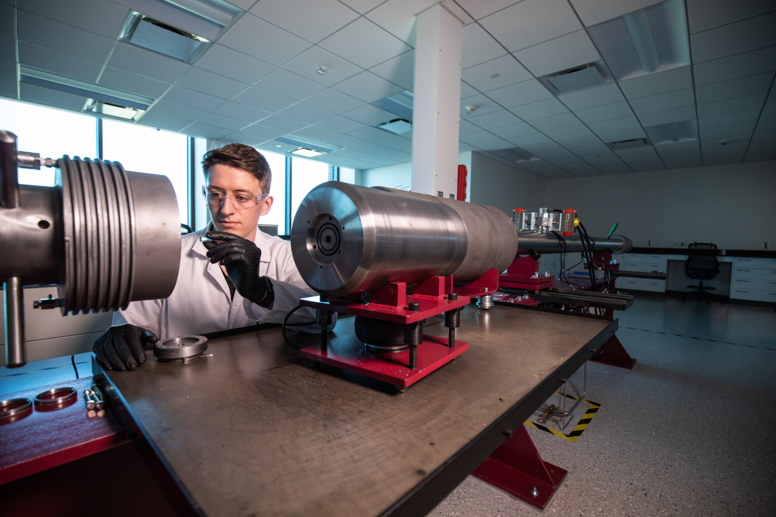 Person working with a machine in the Hypervelocity Impact Lab